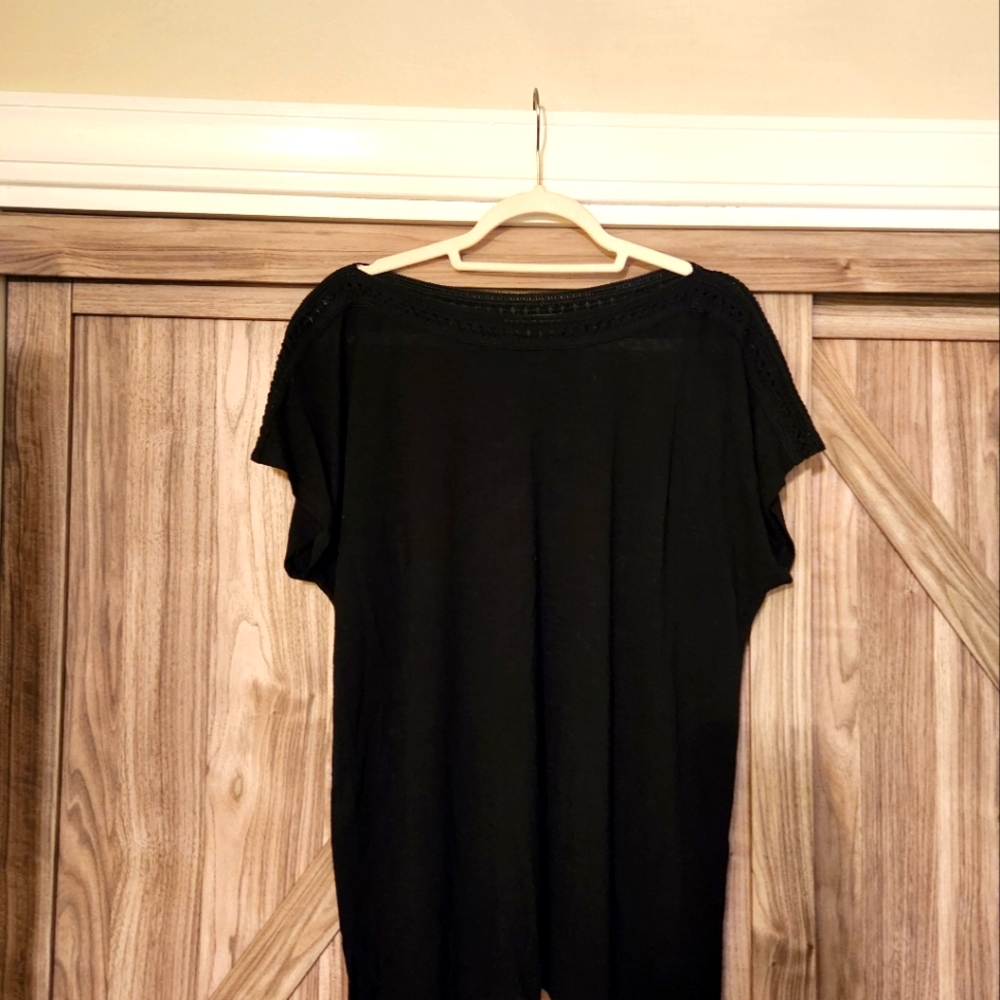 Cute black 1x top with detailed trim along neck and shoulders.